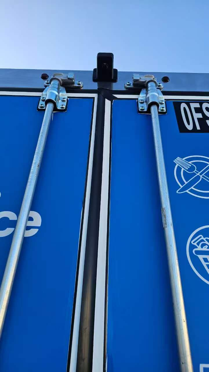 Camera mounted above the meeting edge of two blue box-truck rear doors