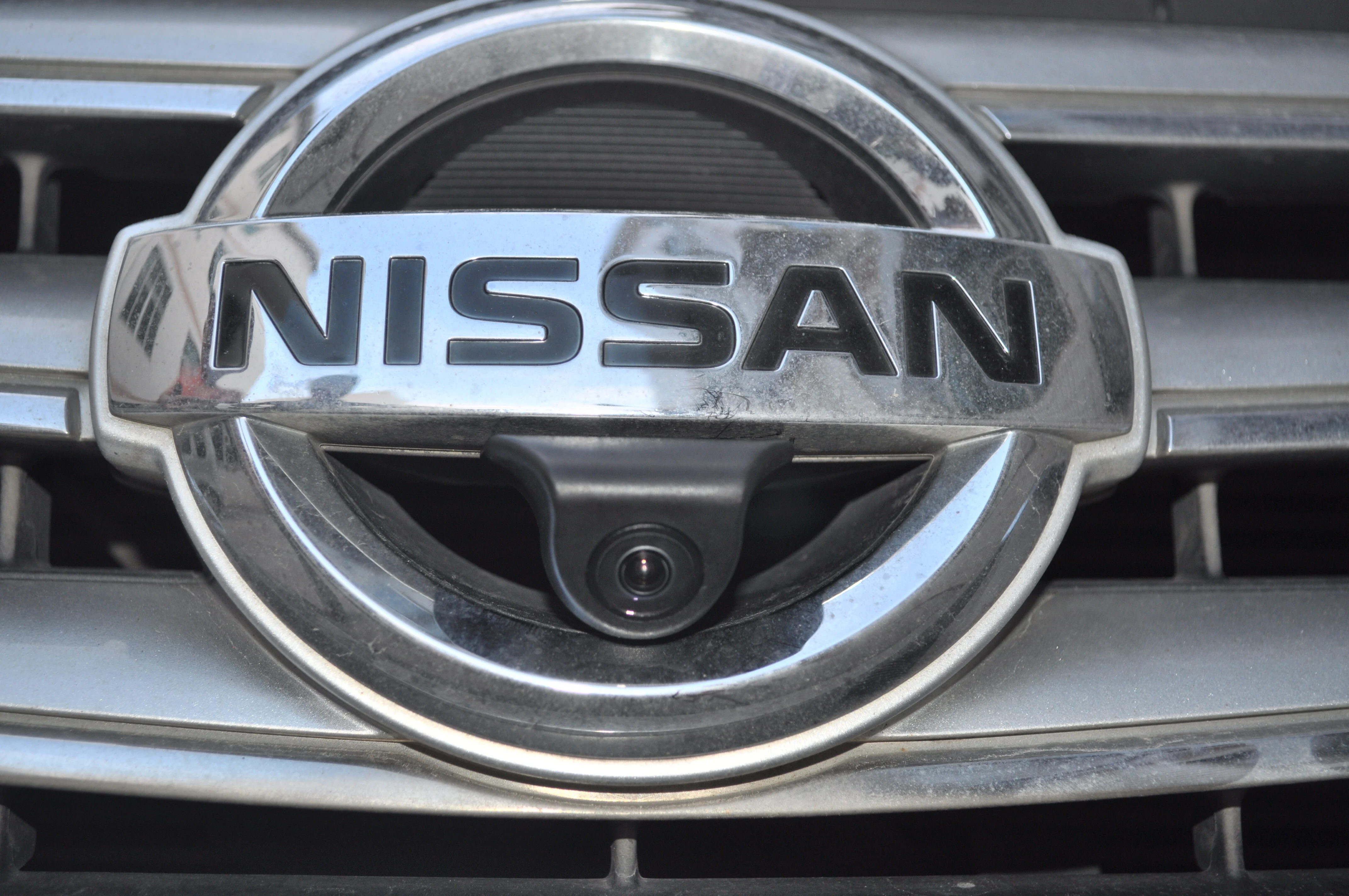 CAM-FN01 front camera installed below a Nissan grille emblem