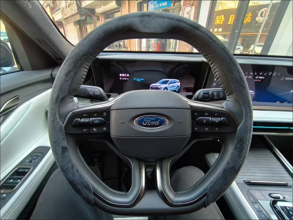 Heated steering wheel cover on a Ford wheel; promotional overlay removed and obscured area reconstructed